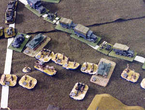 Russian infantry, supported by tanks and artillery, attack the rear echelons of the advancing Axis forces.