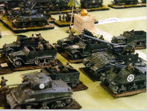 US armour, armoured infantry and self-propelled artillery move forward to attack the German frontline.
